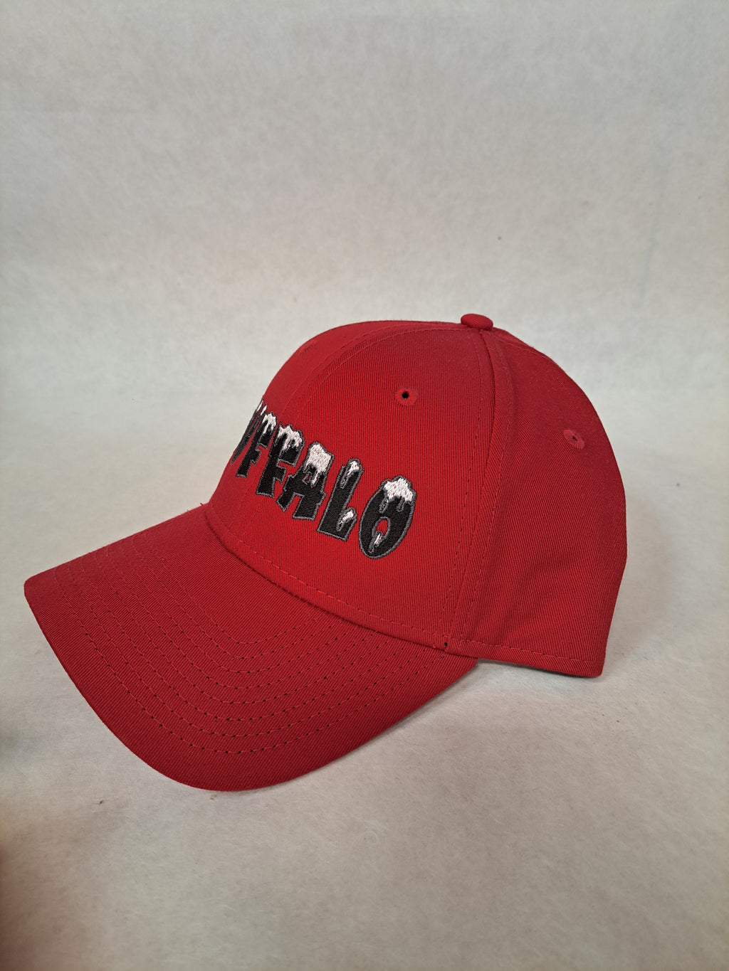 Buffalo with Snow on it with gray border on letters. Red New Era Hat